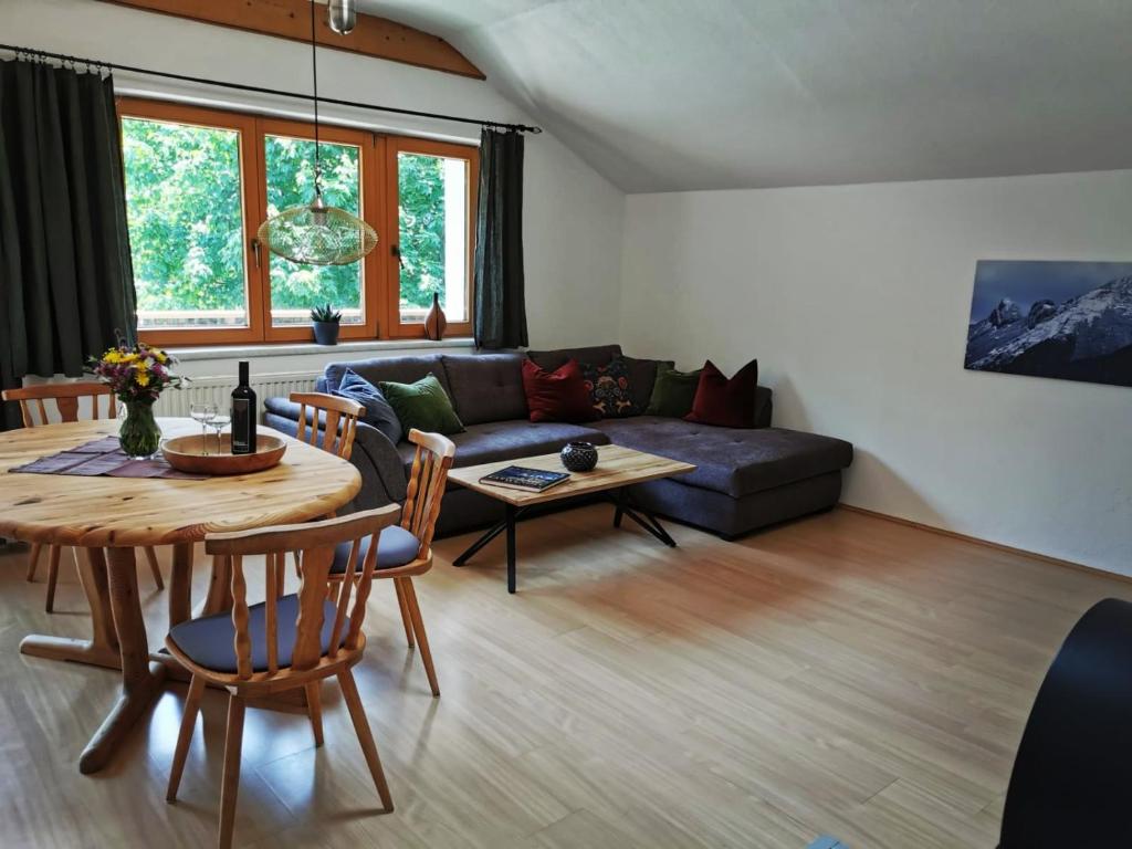 a living room with a table and a couch at Karwendelglück in Scharnitz