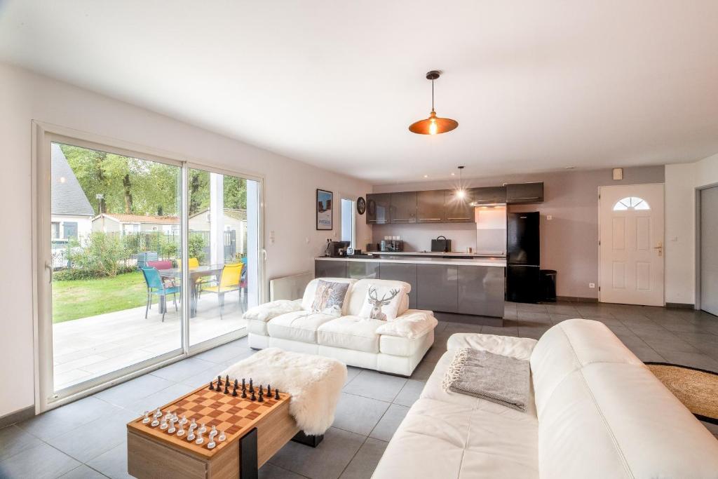 a living room with a couch and a table at La Bigourdane in Lau-Balagnas