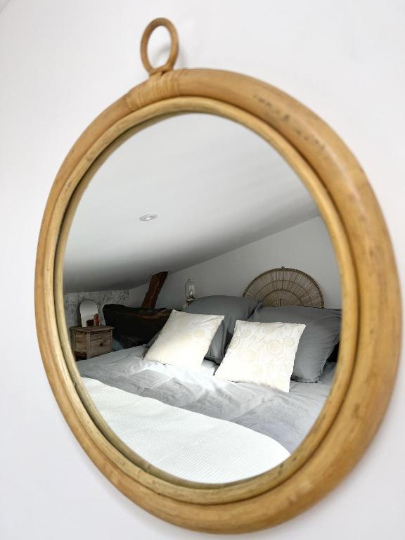 a bedroom with a bed in a wooden mirror at Le Cocon - Coeur de ville in La Rochelle