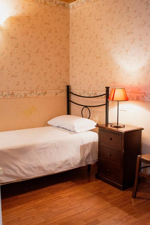 Postel nebo postele na pokoji v ubytování Hotel Capitelli