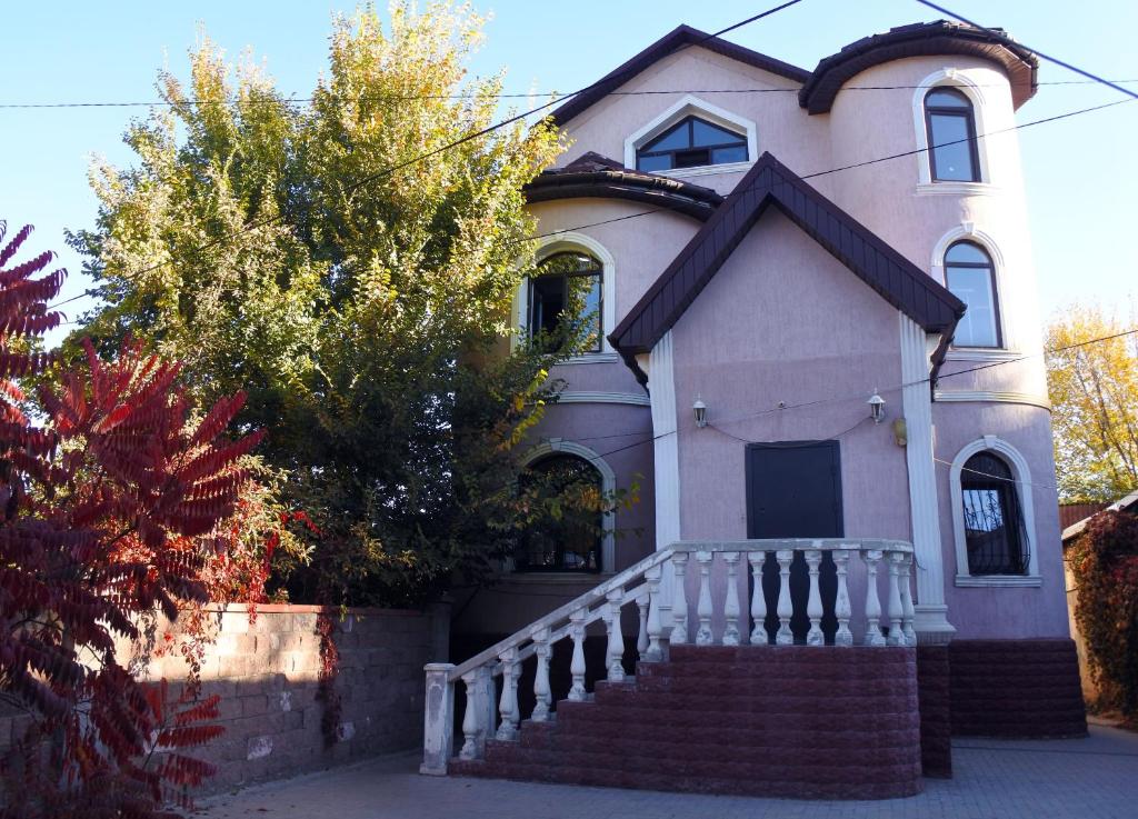 una pequeña casa con una escalera delante en Almaty Backpackers, en Almaty