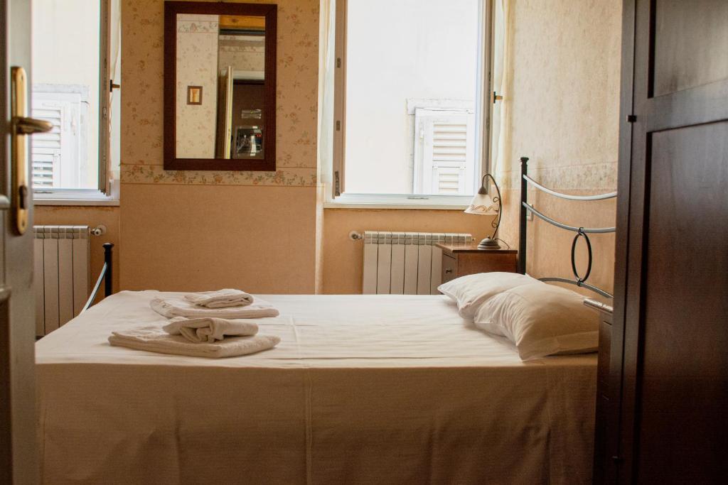 Postel nebo postele na pokoji v ubytování Hotel Capitelli
