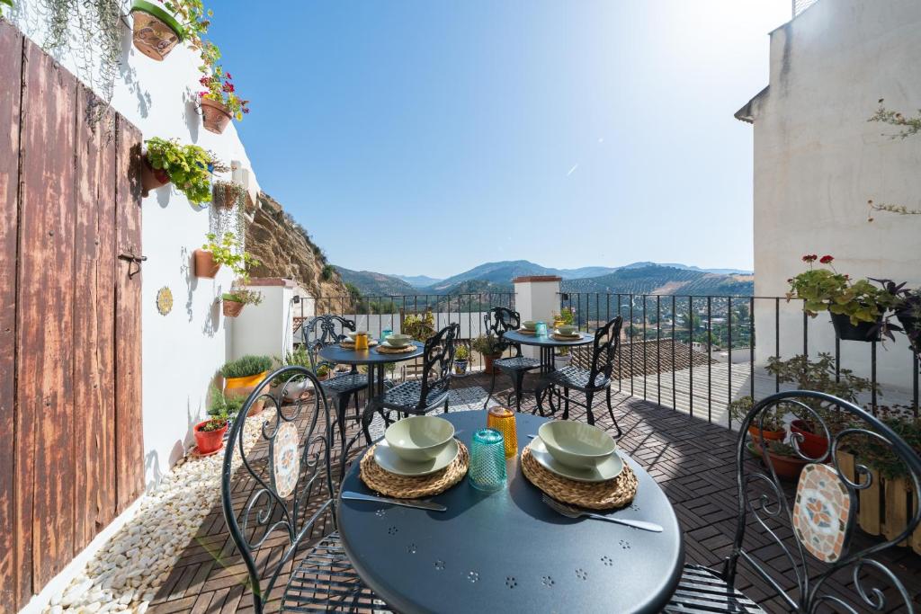 einen Tisch und Stühle auf einem Balkon mit Aussicht in der Unterkunft Villa Moana in Iznájar