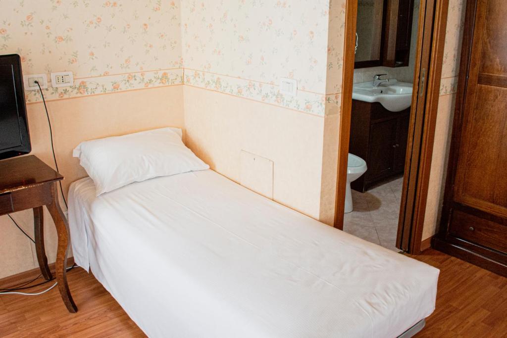 Postel nebo postele na pokoji v ubytování Hotel Capitelli