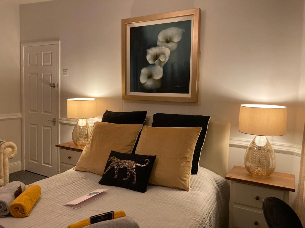 a bedroom with a bed with pillows and two lamps at Beautiful holiday 1 bedroom apartment . in Plymouth