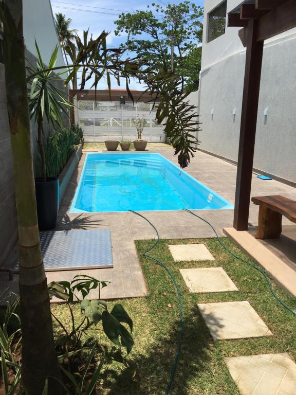 a swimming pool in the middle of a yard at Casa de Praia Tamandare in Tamandaré