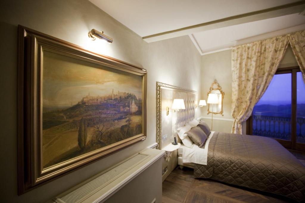 Postel nebo postele na pokoji v ubytování Palazzo Carletti