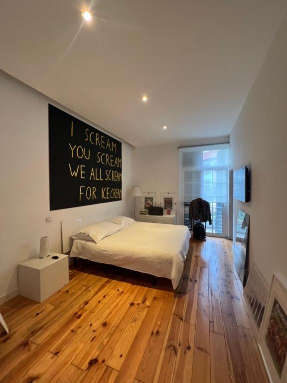 a bedroom with a bed and a sign on the wall at City center boutique apartment in Funchal