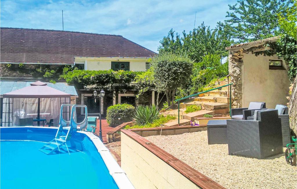 a swimming pool in a yard with a house at Stunning Apartment In La Coquille in La Coquille