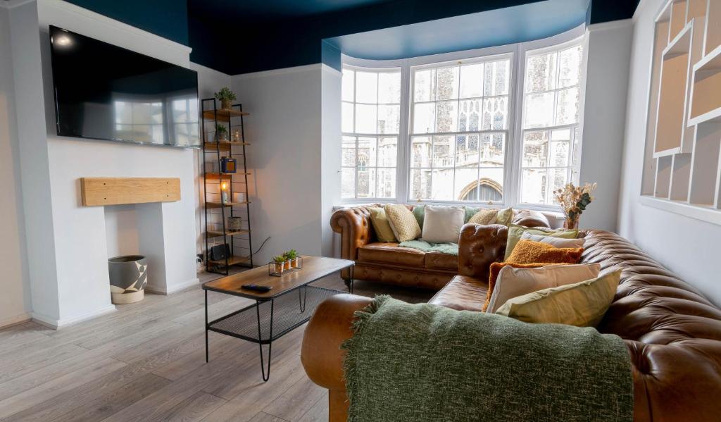 a living room with a couch and a table at The Penthouse in Cromer