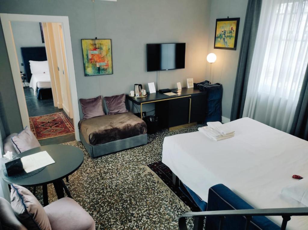 Postel nebo postele na pokoji v ubytování Capriccio Art Hotel