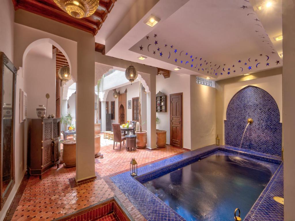 a home with a pool in the middle of a room at Riad Sun of Kech in Marrakesh