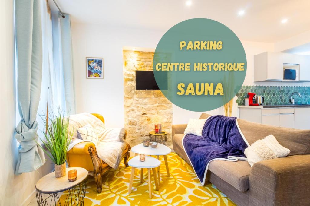 a living room with a couch and a table at Sauna - Le loft des remparts - FloBNB in Laon