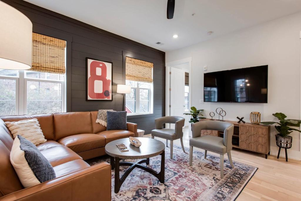 a living room with a couch and a table at The Blair - Sunny Elegance, West End Luxury in Nashville