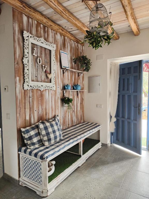 a bench in a room with a wooden wall at Vivienda rural del salado in Jaén