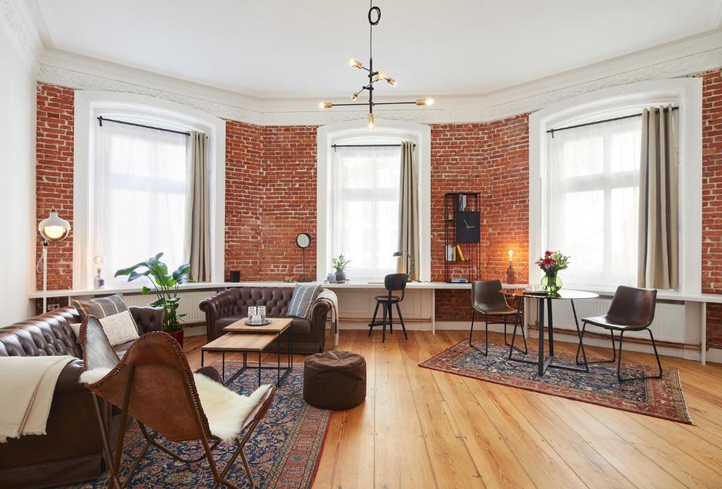 a living room with a brick wall at Aparthotel alsterSuite in Hamburg