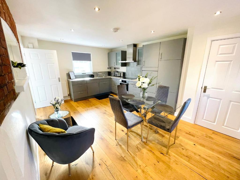 a living room with a table and chairs and a kitchen at 75 Weavers Townhouse in Norwich