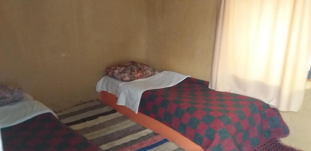 Postel nebo postele na pokoji v ubytování Auberge Camping La Khaima