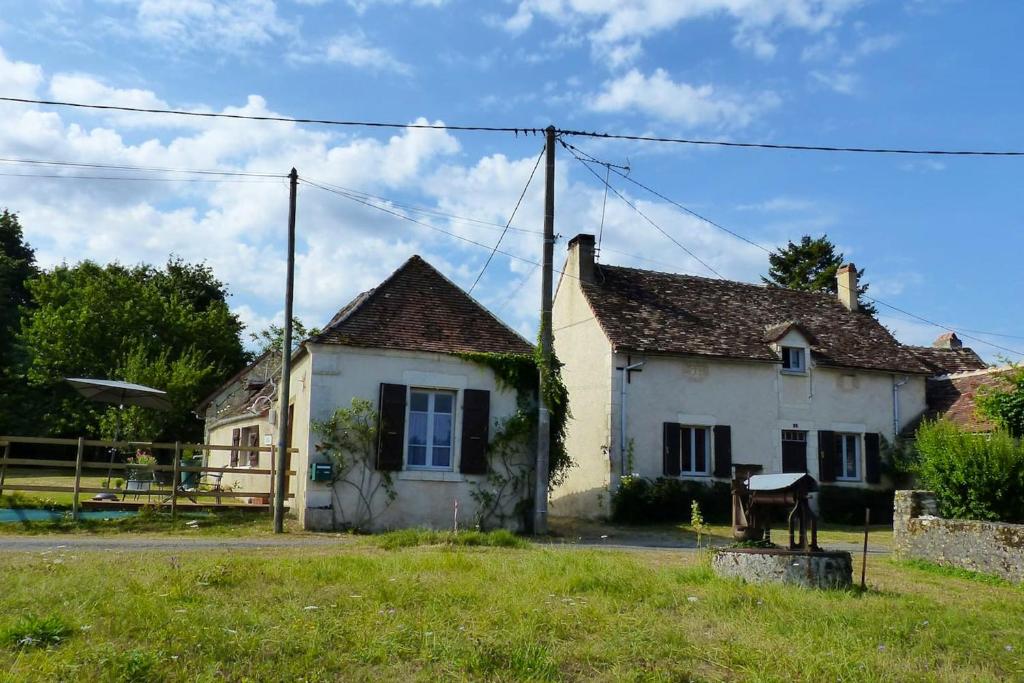 an old house with a horse in front of it at Maison d'une chambre avec jardin a Concremiers in Concremiers