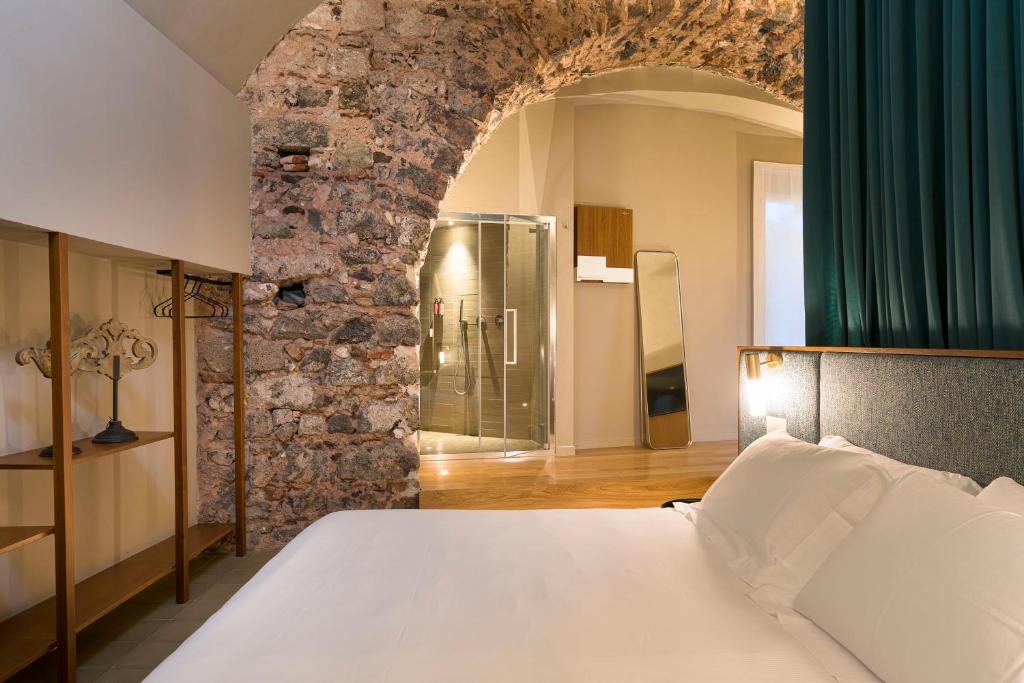 Postel nebo postele na pokoji v ubytování BASTIÒ PRIVATE SUITES