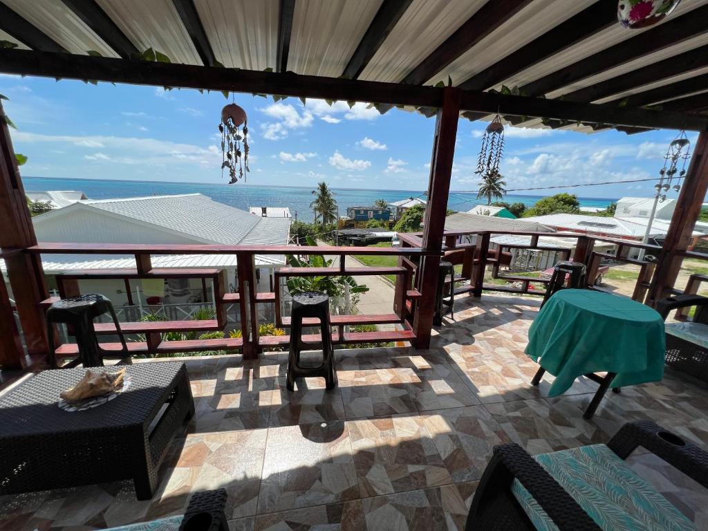 a patio with a table and chairs and the ocean at Posada Ashanty in Providencia