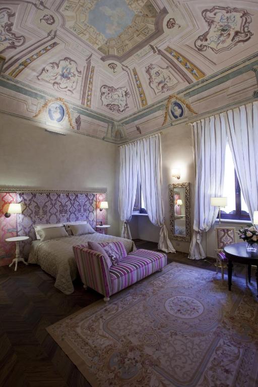 Postel nebo postele na pokoji v ubytování Palazzo Carletti