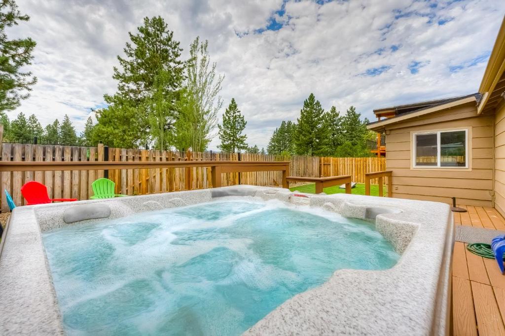 a hot tub in a backyard with a wooden fence at Escape at Edgewood in Stateline
