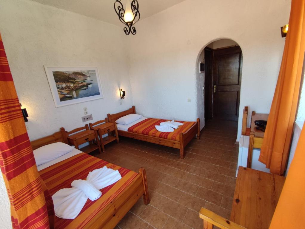 a hotel room with two beds and a hallway at Hotel Tsagarakis Beach in Amoudara Herakliou