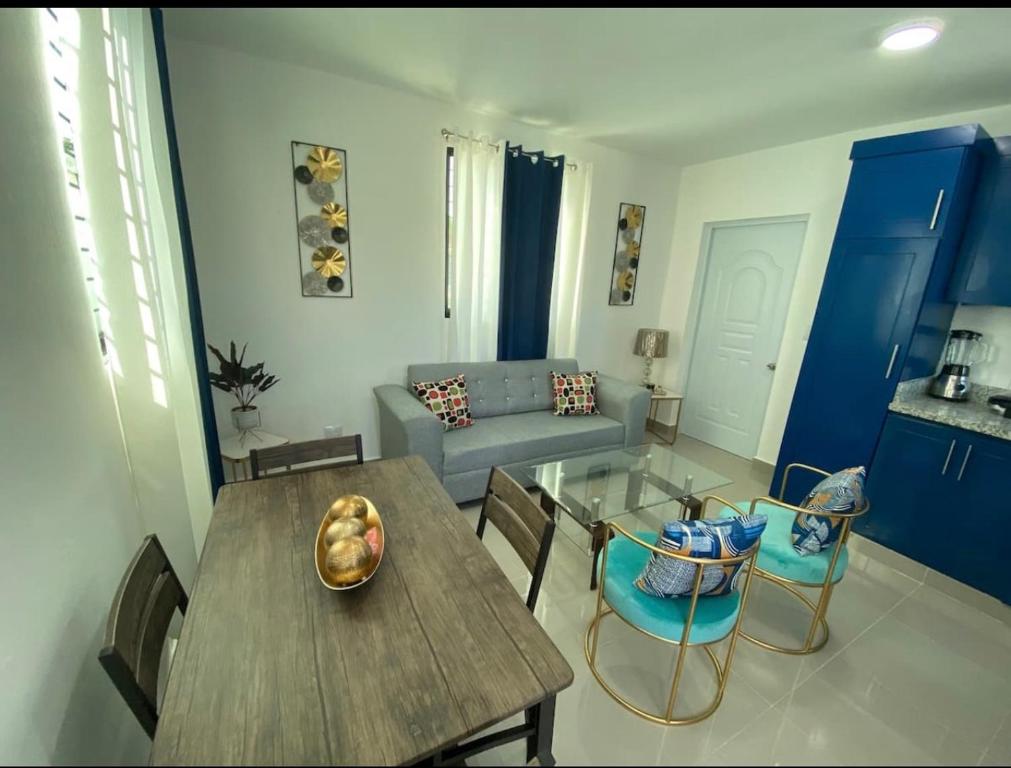 a living room with a table and chairs and a couch at Beautiful Cozy Los Jardines Santiago, 2 Floor in Santiago de los Caballeros