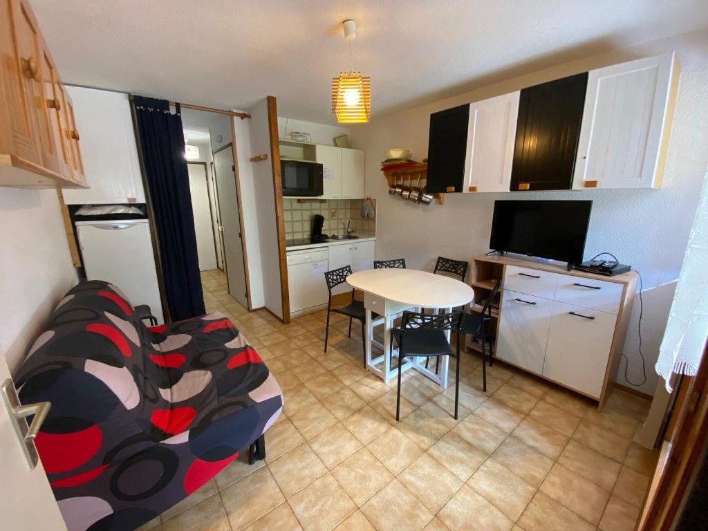 une petite cuisine avec une table et une salle à manger dans l'établissement Charmant 2 pièces avec balcon, parking, proche des pistes - La Clusaz - FR-1-459-34, à La Clusaz