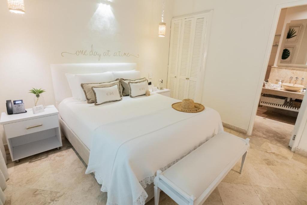 Postel nebo postele na pokoji v ubytování Casa Diluca Cartagena Hotel Boutique