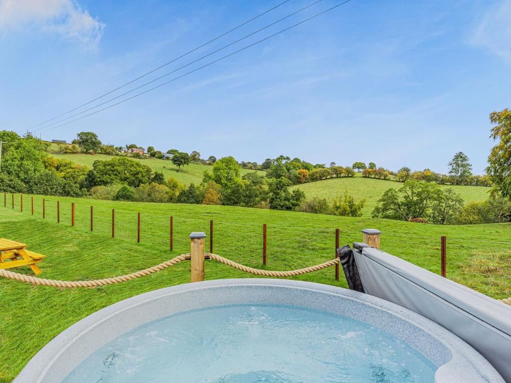 a hot tub in the middle of a field at Oak-uk36258 in Llanfair Caereinion
