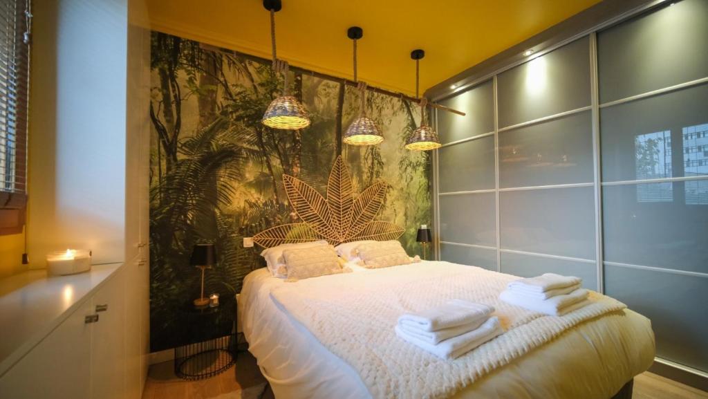 a bedroom with a bed with towels on it at Luxury Copacabana proche Orly et Paris avec baignoire extérieur in Draveil