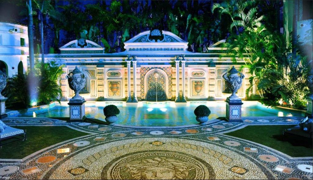 a large ornate building with a large fountain in front of it at The Villa Casa Casuarina in Miami Beach