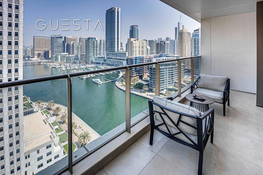 a balcony with a chair and a view of a city at Sparkle Tower, Dubai Marina in Dubai