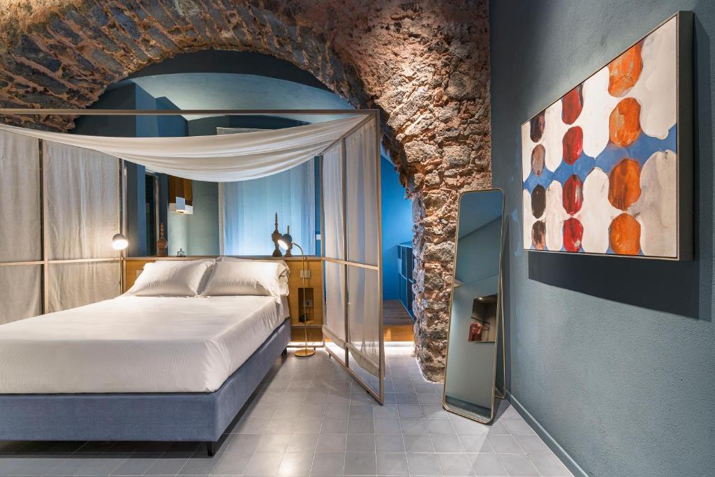 Postel nebo postele na pokoji v ubytování BASTIÒ PRIVATE SUITES