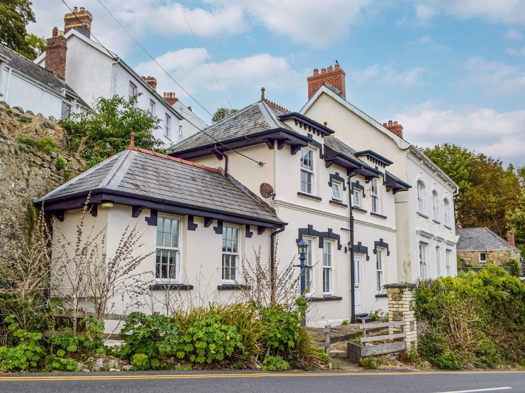 a white house with a black roof at Ty Glyndwr in Goodwick