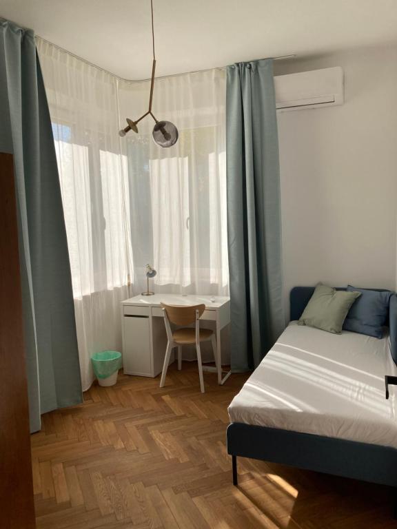 a bedroom with a bed and a desk and a table at Apartament z klimatyzacją in Krakow