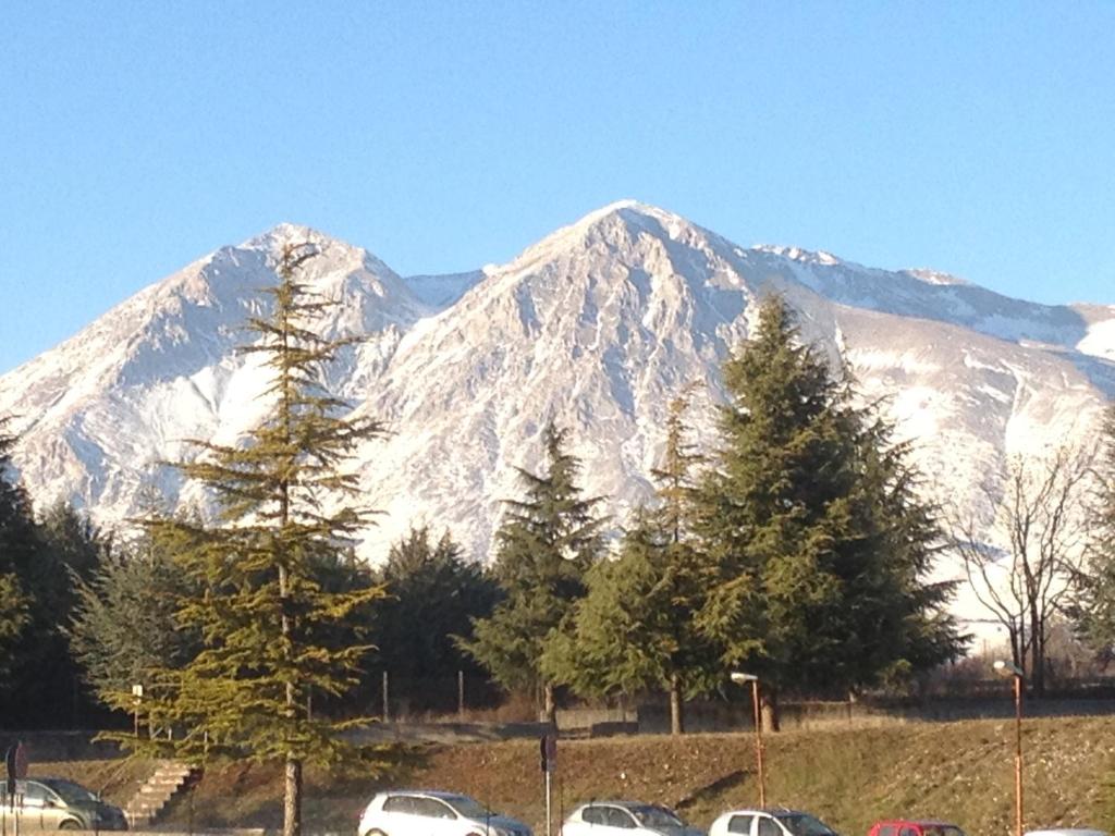 a snow covered mountain with cars parked in a parking lot at La Collina di Peppino in Trasacco