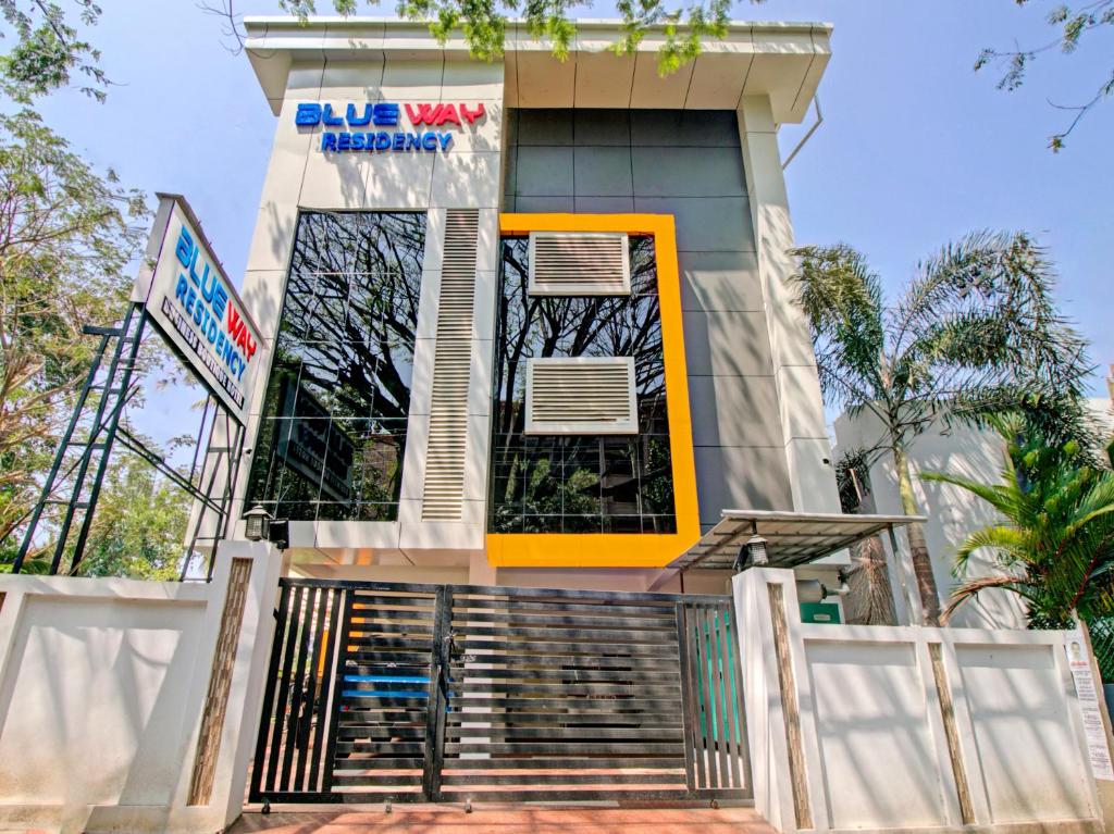 a building with a yellow door and stairs in front at BLUEWAY RESIDENCY BUSINESS BOUTIQUE HOTEL in Trivandrum