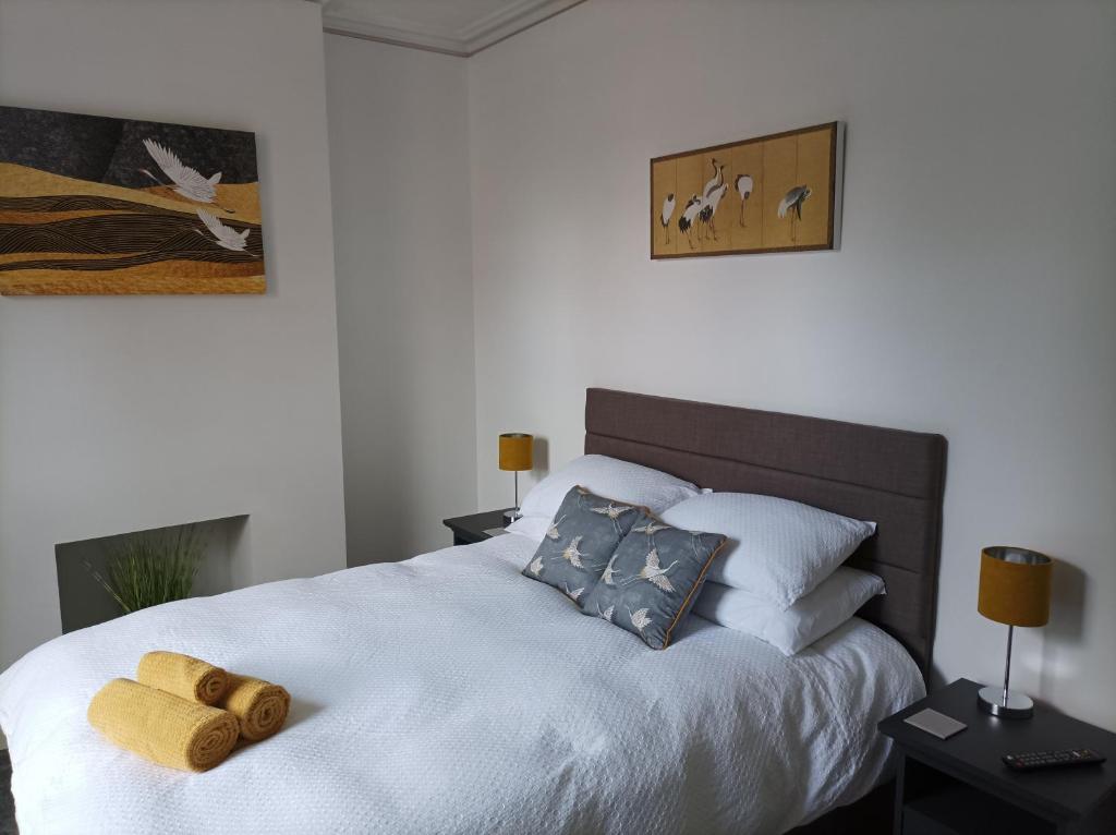 um quarto com uma grande cama branca e 2 almofadas em Victorian Renovation Room 1 em Liverpool