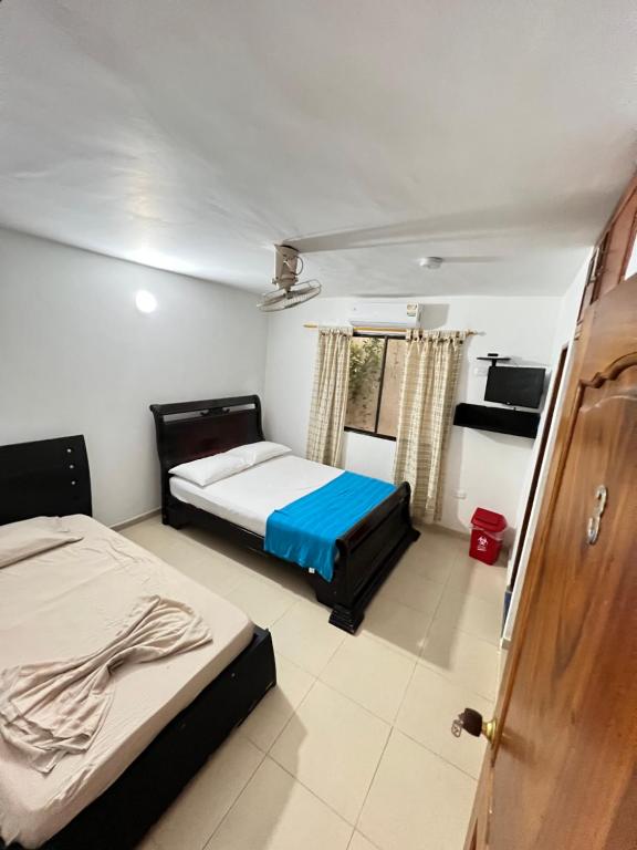 Postel nebo postele na pokoji v ubytování Hotel Taganga Plaza Santa Marta