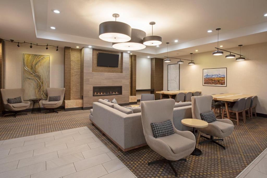 a lobby with a couch and chairs and a fireplace at Holiday Inn & Suites Durango Downtown by IHG in Durango