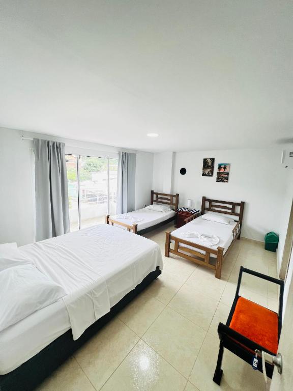 Postel nebo postele na pokoji v ubytování Hotel Taganga Plaza Santa Marta
