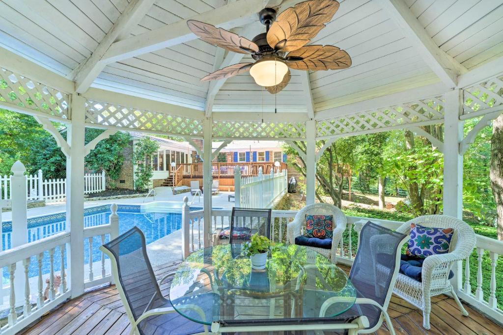 a screened porch with a glass table and chairs at Dobson Getaway with Private Pool and Game Room! in Dobson