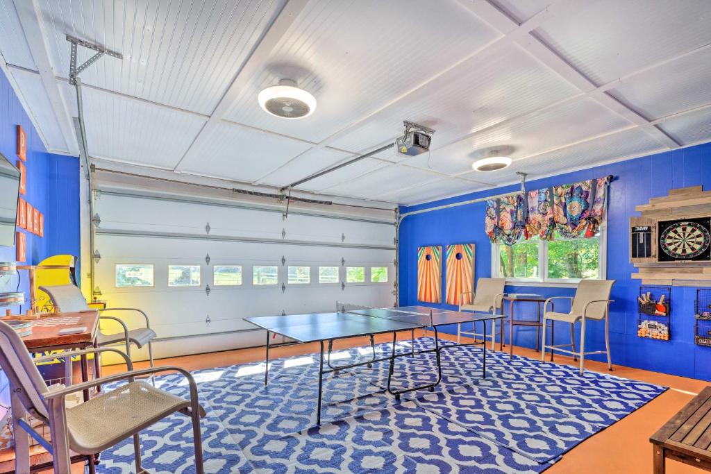 a room with a ping pong table and chairs at Dobson Getaway with Private Pool and Game Room! in Dobson