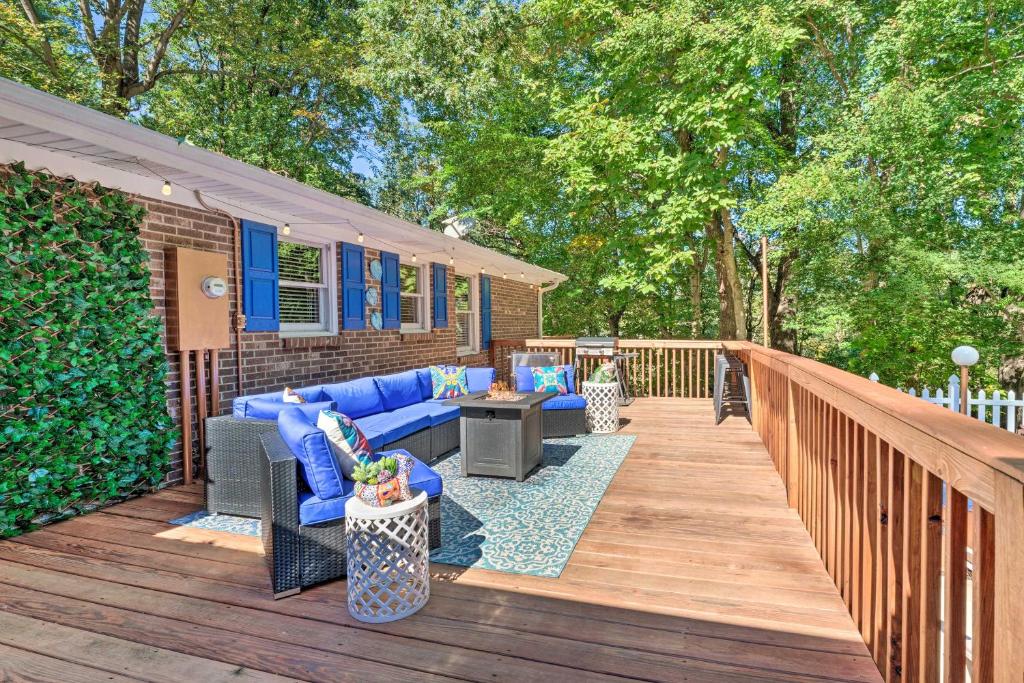 a patio with a blue couch and chairs on a wooden deck at Dobson Getaway with Private Pool and Game Room! in Dobson