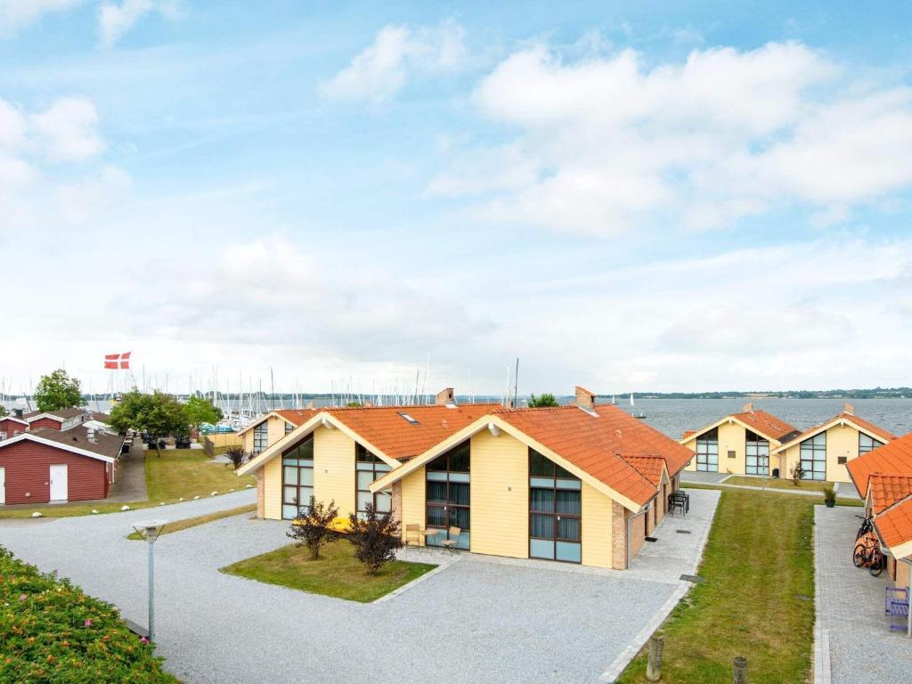 a row of houses with orange roofs at 8 person holiday home in Egernsund in Egernsund