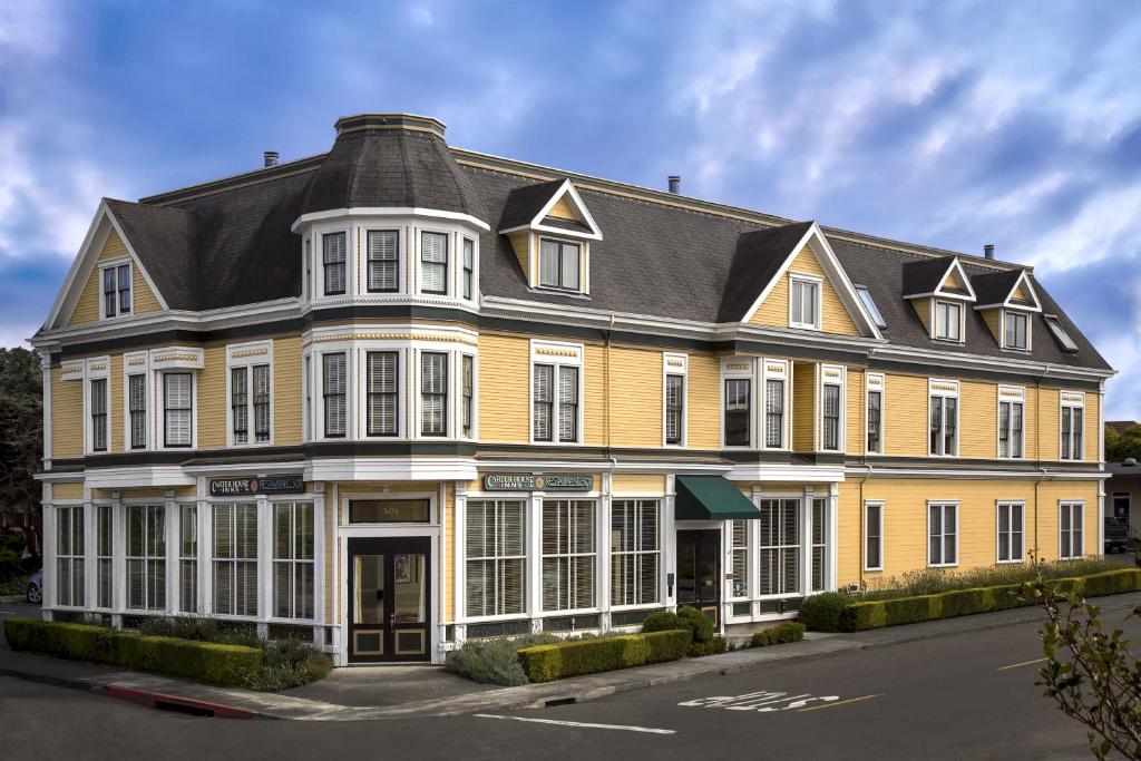 a large yellow building with a black roof at Carter House Inns in Eureka