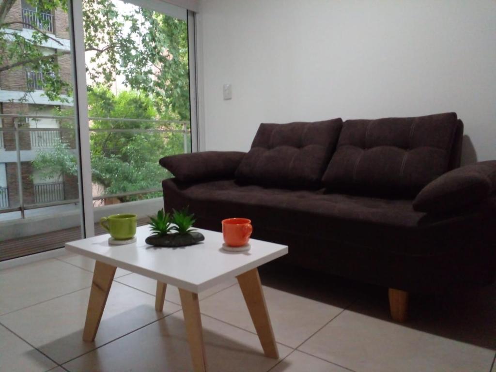 a living room with a couch and a coffee table at Lourdes in Rosario